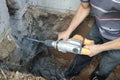 Jackhammer in action, pneumatic construction tool, drilling a hole in the concrete wall Royalty Free Stock Photo