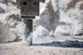 Jackhammer hammering concrete for hole and making dust Royalty Free Stock Photo
