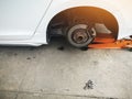 jacking up a car with the emergency jack for changing car tire