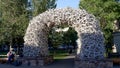 JACKSON HOLE, WYOMING, USA -AUGUST 17, 2017: a wide shot of a busker sitting beside an antler arch in jackson hole Royalty Free Stock Photo