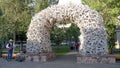 JACKSON HOLE, WYOMING, USA -AUGUST 17, 2017: a wide view of a busker standing beside an antler arch in jackson hole Royalty Free Stock Photo