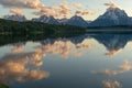Jackson Lake Reflects clouds with pine Trees and Tetons Royalty Free Stock Photo