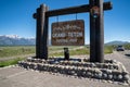 Jackson, Wyoming - June 27, 2020: A black labrador retreiver dog poses at the Grand Teton National Park sign Royalty Free Stock Photo