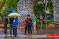 JACKSON, WYOMING, USA, JUNE, 07, 2018: Unidentified people holding umbrellas in front of elk antler arches curve over