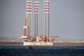 Oil rig moored in harbor with legs lifted