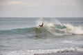 A surfer rides a wave at Jaco Beach, Costa Rica