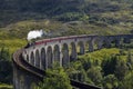 Jacobite steam train on Glenfinnan Viaduct approaching, Highlands, Scotland, UK