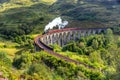 Jacobite steam train on Glenfinnan viaduct in Scotland, United Kingdom Royalty Free Stock Photo