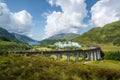 Jacobite steam train, a.k.a. Hogwarts Express, passes Glenfinnan viaduct Royalty Free Stock Photo