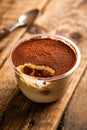 Jacopo Tiramisu Mousse served in jar isolated on wooden table top view of arabic sweet dessert