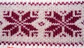 Jacquard knitted pattern. Geometric ornament for Christmas or New Year. Knitted brown snowflakes or flowers on a beige