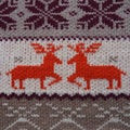 Jacquard knitted pattern. Geometric ornament for Christmas or New Year. Two red deer on a white knitted background