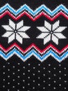 Jacquard knitted pattern. Geometric ornament for Christmas or New Year. Knitted white snowflake, blue zigzag, dots on a