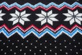 Jacquard knitted pattern. Geometric ornament for Christmas or New Year. Knitted white snowflake, blue zigzag, dots on a