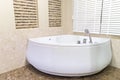 Jacuzzi in corner of bathroom Royalty Free Stock Photo