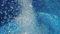 jacuzzi jet in bubbly blue water in a thermal spa pool Royalty Free Stock Photo