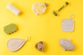 Jade face roller, anti cellulite massager, loofah and bamboo sponges on yellow surface. Frame from tools for beauty routine from Royalty Free Stock Photo