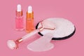 Jade face roller and Gua sha stone for facial massage. Home skin care anti-aging tools, face serum bottle, massage roller. Natural Royalty Free Stock Photo