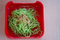 Jade noodle on red tray