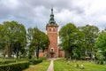 Old church made of bricks with lush green surrounding cemetery Royalty Free Stock Photo