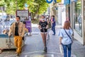 Jaen, Spain - June 18, 2020: Young woman riding an electric scooter by the sidewalk wearing a protective mask