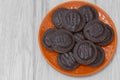 Jaffa cakes biscuits stacked on an orange plate.