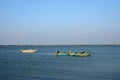 Several blue and yellow boats moored anchored in waters of Jaffna Sri Lanka