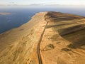 Jagged coasts and cliffs overlooking the ocean. Aerial view. Lanzarote, road leading to the Mirador del Rio.