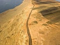 Jagged coasts and cliffs overlooking the ocean. Aerial view. Lanzarote, road leading to the Mirador del Rio.