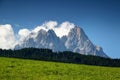 Jagged Dolomiti Sesto peaks tower over forest and sunny meadow Royalty Free Stock Photo