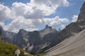 Jagged and dry mountains with rugged peaks and sharp slopes, white clouds in the blue sky