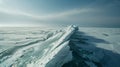 The jagged edges of icebergs jut out from the crystalclear waters a stark contrast to the smooth frozen surface that