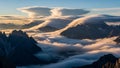 Peaks piercing through a dense layer of clouds at dawn with surreal Royalty Free Stock Photo