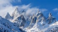 The jagged peaks of a snowcovered mountain range stand as a stark contrast to the smooth undulating form of the Royalty Free Stock Photo
