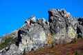 JAGGED ROCK FACE WITH VIBRANT BLUE SKY