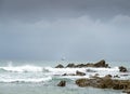 Jagged rock pinnacles juxtaposed with distant sailing boat,Dollar Cove,Gunwalloe, Helston,South Cornwall,England,UK Royalty Free Stock Photo