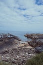 Rocky jagged Scottish coast beach under bright blue summer sky