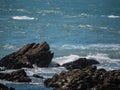 Jagged rocks jutting from blue ocean