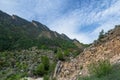 Jagged rocky ridge covered with sparse forest against a blue sky. Minimalistic atmospheric landscape with rocky mountain wall with Royalty Free Stock Photo