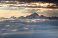 Jagged snowy Triglav peak rises dramatically over sea of clouds Royalty Free Stock Photo