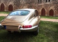 Jaguar E Type 4.2 rear view of the classic engish sports coupe in front of a medieval brick building in Lehnin, Germany, August 21