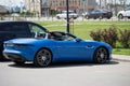 Jaguar F-Type sporty bright blue open-top car in parking lot