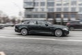 Jaguar XJ X351 black color car, in motion on a city street