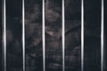 Jail bars, empty dark prison cell