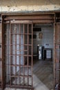 jail cell with iron bars that are hanging down the door