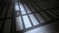Jail cells bars casting shadows on floor. Royalty Free Stock Photo