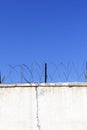 Jail wall. Highly protected prison wall with barbed wire fence Royalty Free Stock Photo