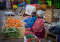 JAIPUR, INDIA - AUGUST 25 2017: Indian women sells assorted food in the streets in Jaipur, India. In India poor women