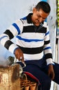 Jaipur, India - December 30, 2014: Indian man pouring milk tea in the terra cotta pottery
