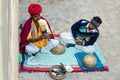 Jaipur, India - December 29, 2014: Snake charmer is playing the flute for the cobra in the Amber Fort